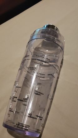 Martini shaker with ingredients of drinks written right on the mixer.