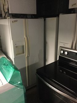 Side by side white refrigerators/ warranty / delivery and installation are available