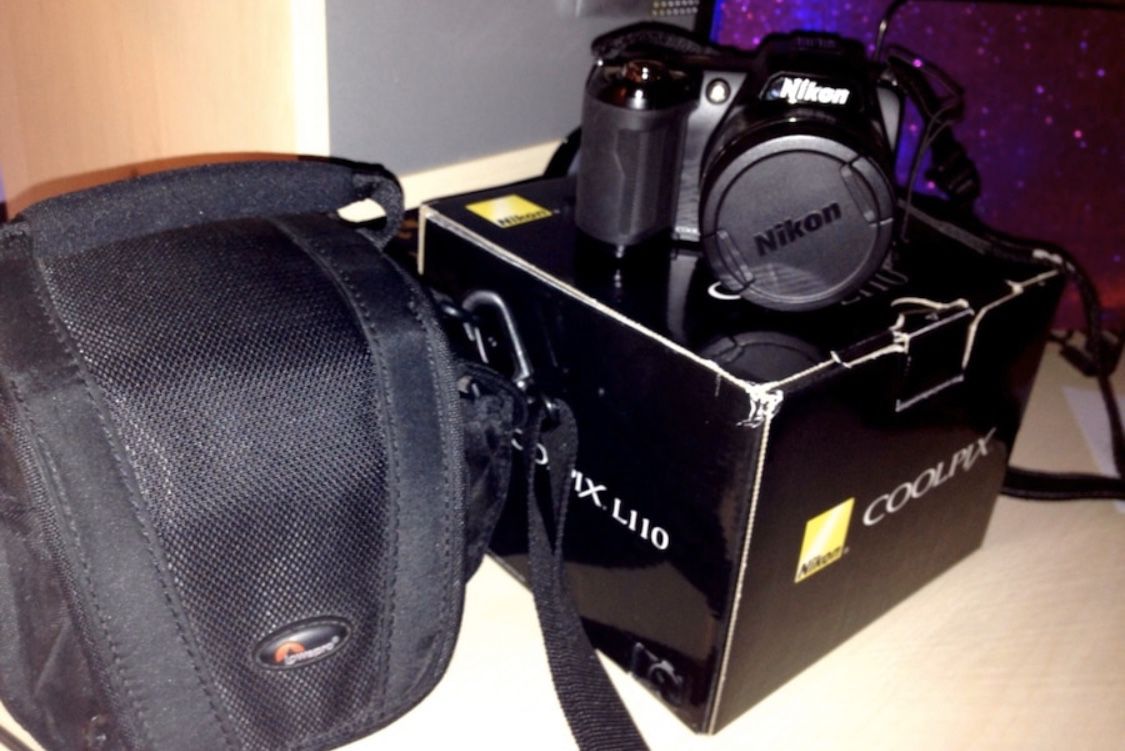 Black canon eos dslr camera with bag