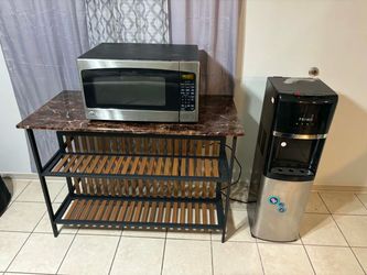 Table , microwave , and water dispenser