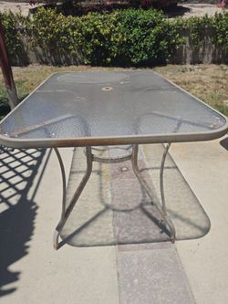 Glass top metal patio table