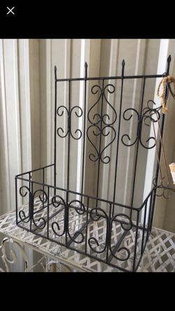 Metal garden decor. Holds potted flowers beautifully. Hangs on wall/fence or stands.