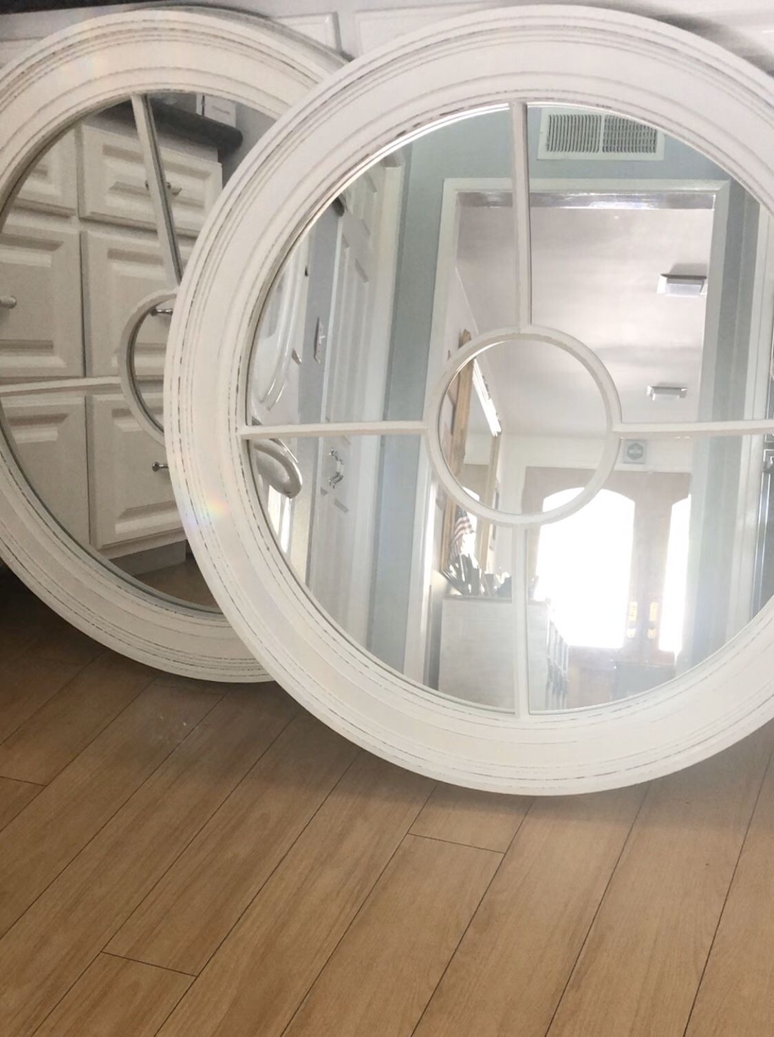 Pair of round Cape Cod Style mirrors.