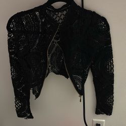 black lace cropped jacket with a zipper front.