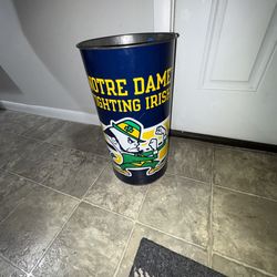 Lot of 8 Notre Dame fighting Irish Items metal garbage can, flag,sweatpants 5 shirts 3 are vintage