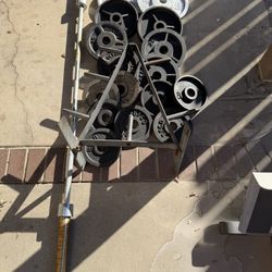 Olympic weights 300lbs total plus 7ft 45lbs bar