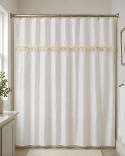Croscill Home Fashions textured white shower curtain with decorative fringe accent.