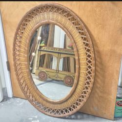 Vintage resin wicker mirror frame with Syroco oval mirror.34in. tall 26in. wide.