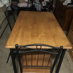 Solid wood and metal table and four chairs.