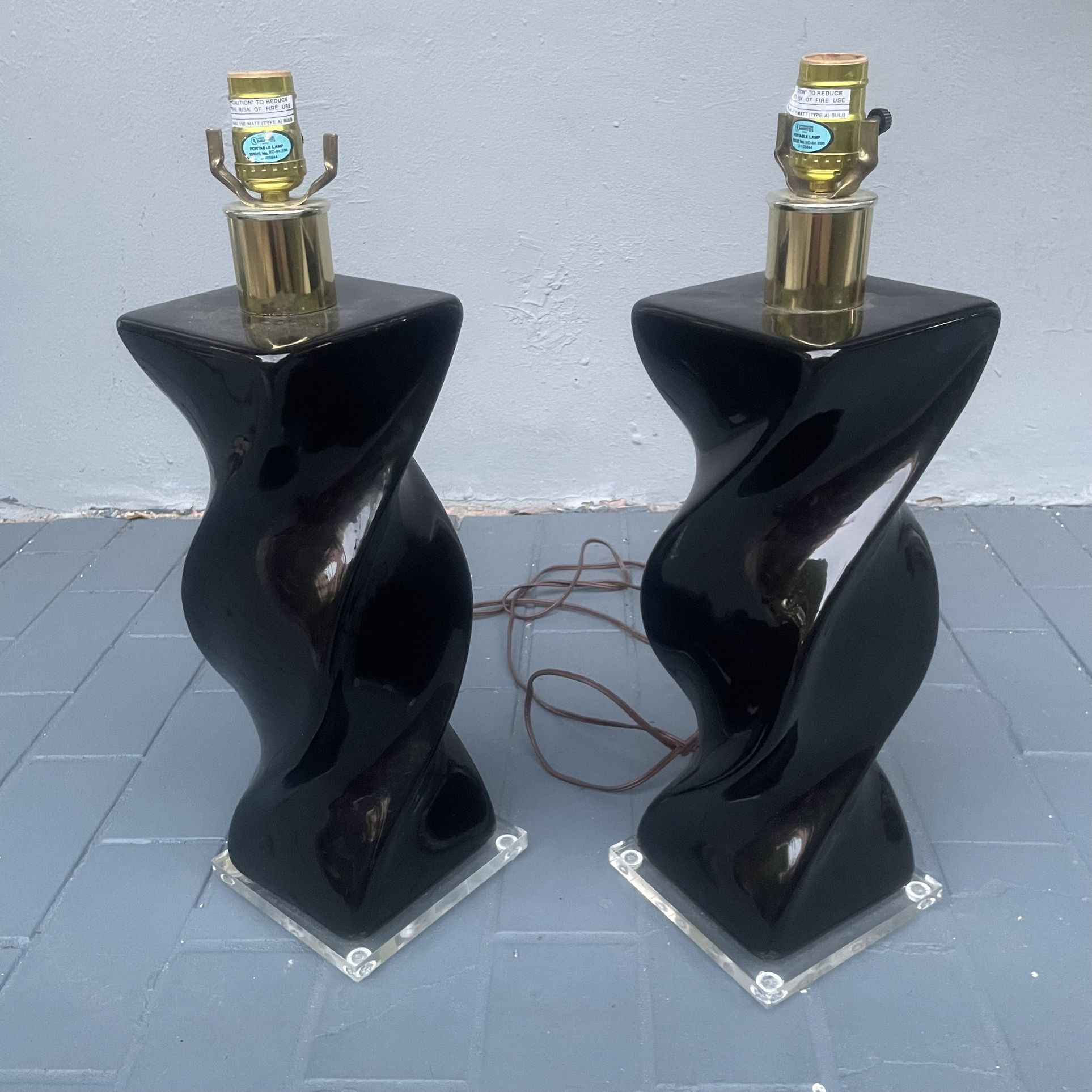 Pair of post modern twisted black ceramic lamps that measure 6” x 6” x 20” that can be seen near the Miami Design District.
