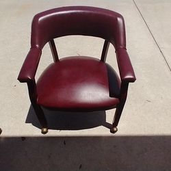 2 Burgundy Leather Captains Chairs 
On Rolling Casters