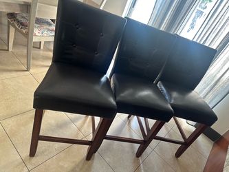 Three leather kitchen counter chairs