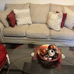 Couch And Loveseat with three glasses tables and carpet 