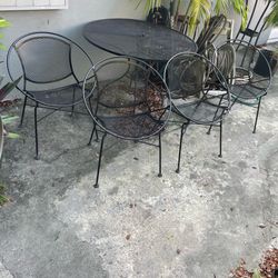 Set of 4 Tempestini for Salterini radar chairs and 42” diameter wrought iron table near the Miami Design District