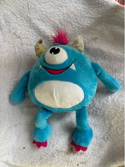 This is a blue, one-eyed monster plush doll