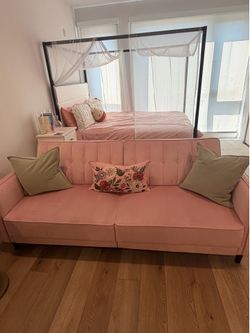 Selling cute and comfy pink futon couch!