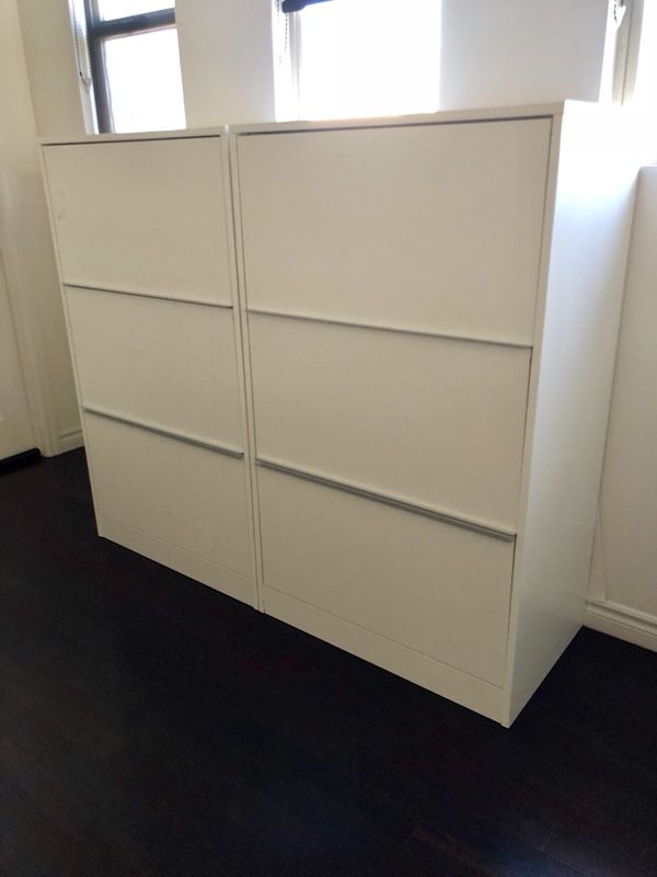 Two kinda large white covered “bookcases”