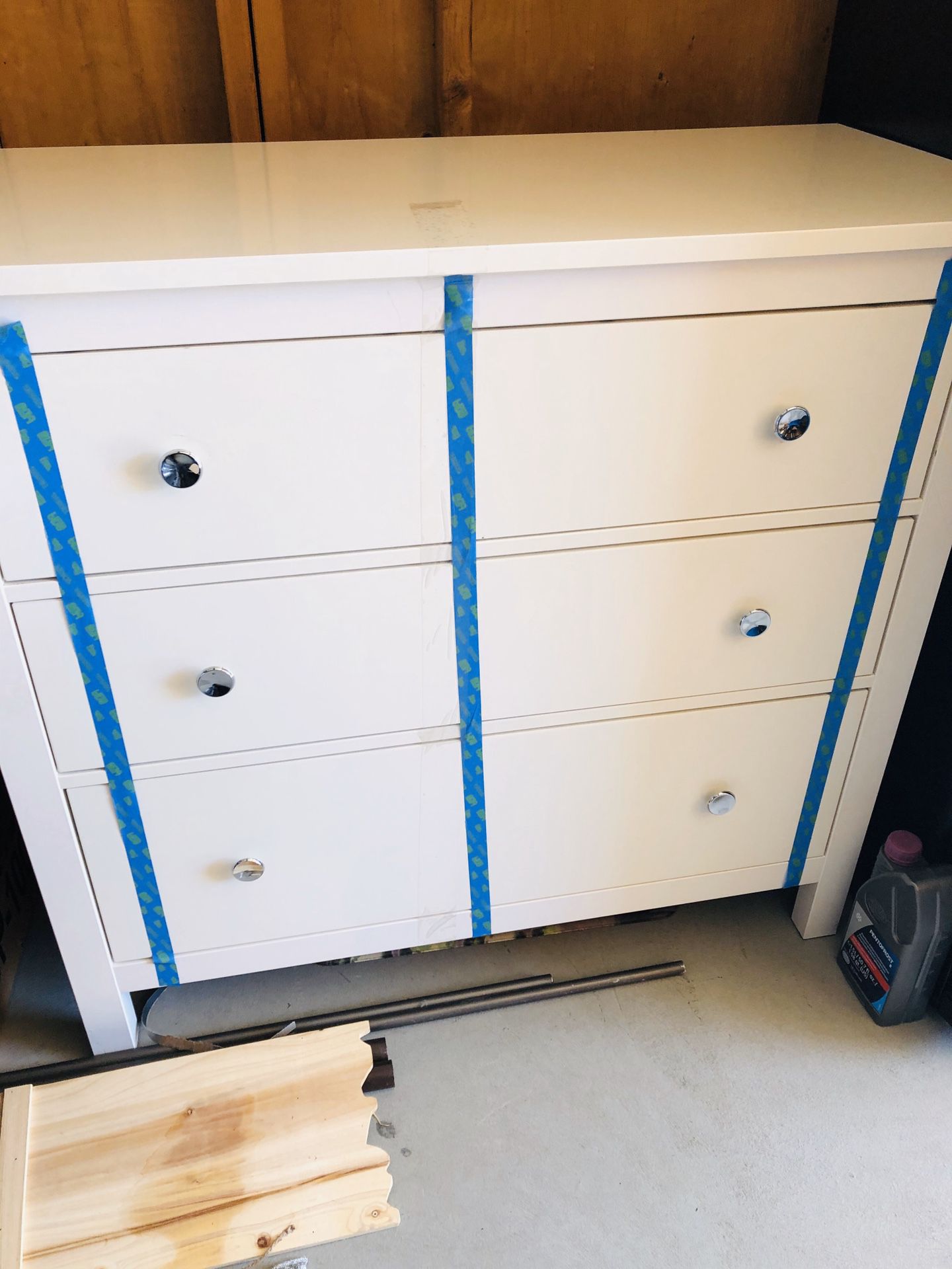 White three drawer dresser with round glass top nightstand
