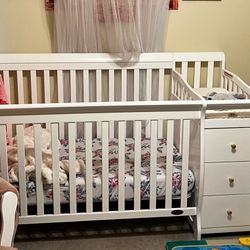 Convertible crib with changing table and drawers, jungle jumperoo, swing, and large playpen