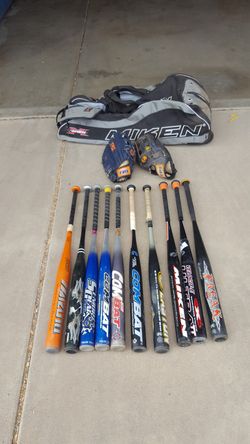 Softball equiptment bats and gloves and bag