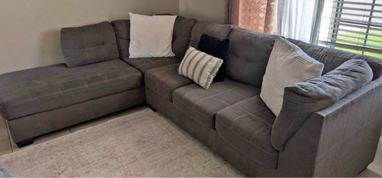 Grey couch with pullout bed the bed still has plastic on it great condition clean we sell all the time delivery $40 local