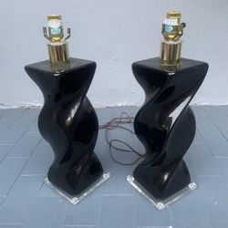 Pair of post modern twisted black ceramic lamps that measure 6” x 6” x 20” that can be seen near the Miami Design District. 