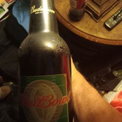 A budweiser glass bottle used for a piggy bank or whatever