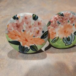 Decorative floral knobs for cabinets or drawers.