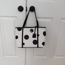 Dana Buchman tote bag featuring a black polka dot pattern and black shoulder straps.