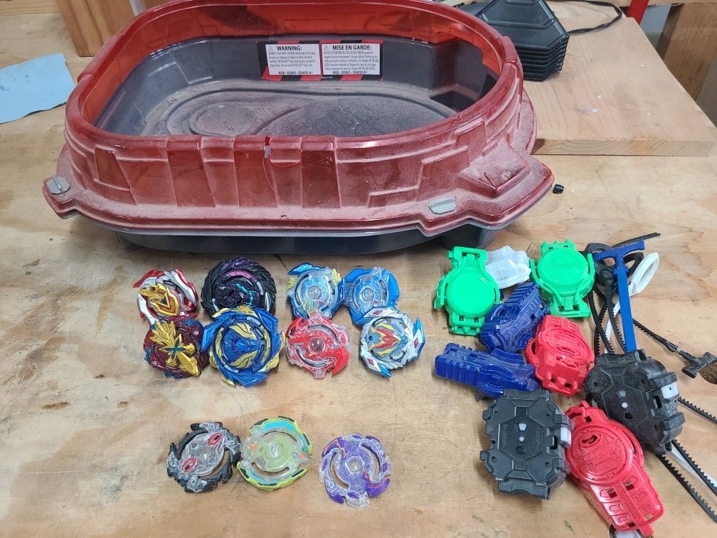 Assorted Beyblades And Arena