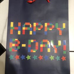 This is a large, block-themed "Happy Birthday" gift bag featuring a colorful building block pattern. 