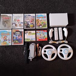 NINTENDO WII with 8 GAMES + 2 REMOTES + 2 WHEELS