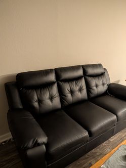 Three piece black leather living room set