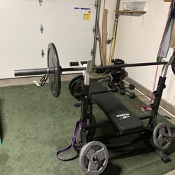 Bench Press With Olympic Barbell Included And Leg Curl Attachment 