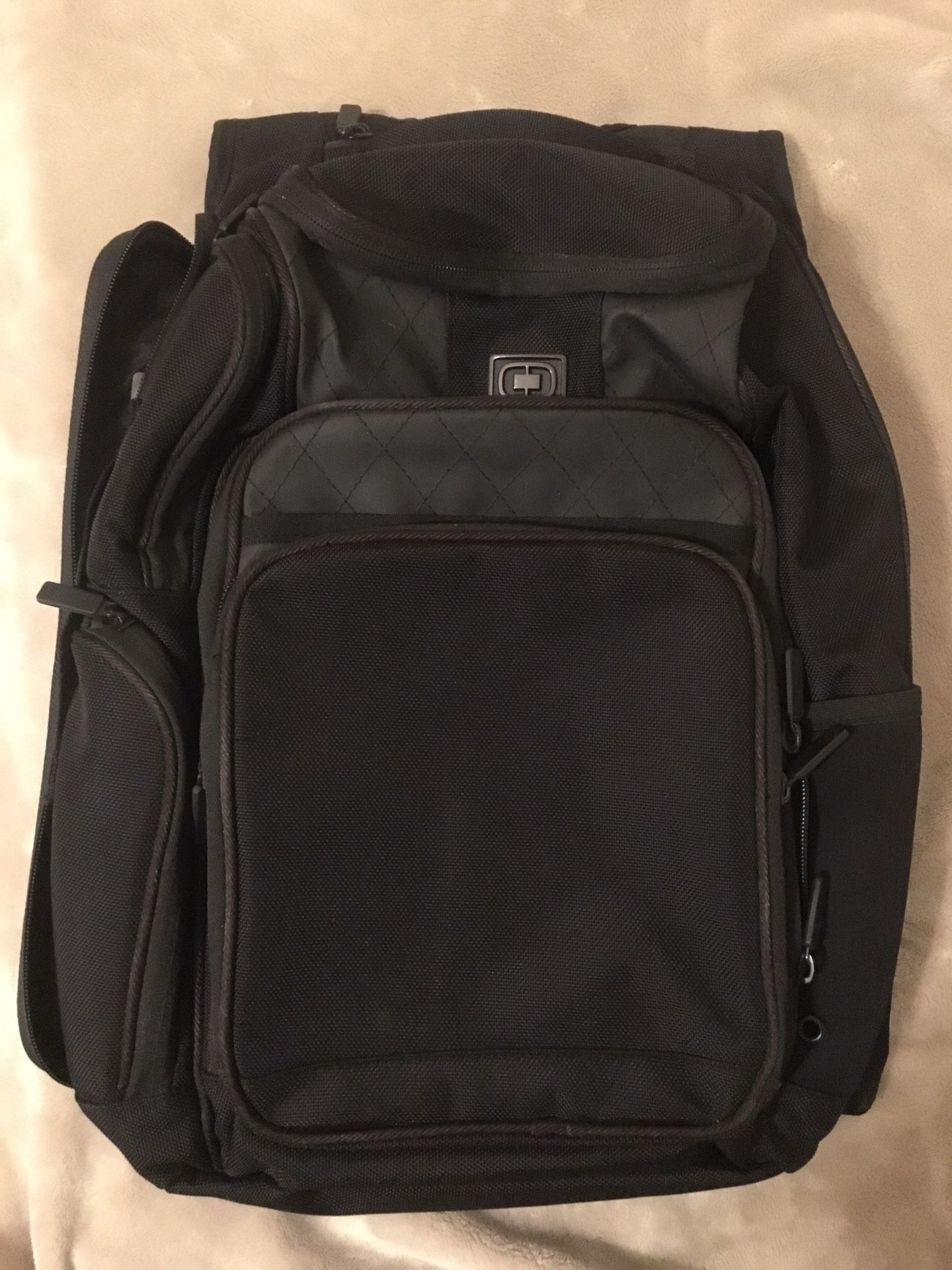 Ogio Backpack. This model features LPS (Laptop Protection System) and AFS (Air Flow System). Has lots of compartments. Black in color.