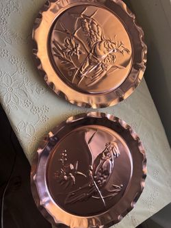 2 beautiful copper colored plates with hangers