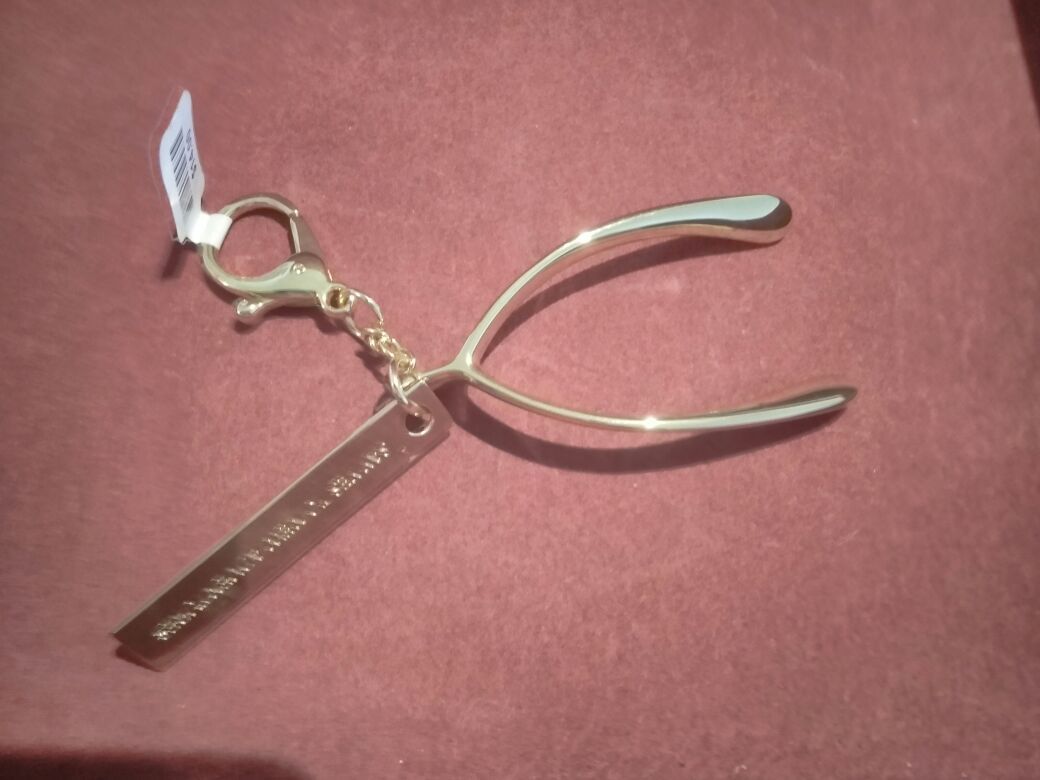 Anthropology Wishbone Keychain-it says "Say yes to new adventures".