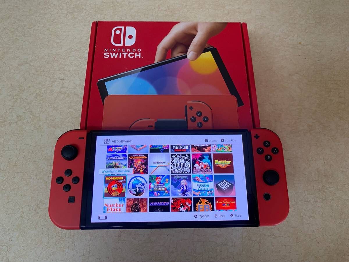 SWITCH OLED with 125 GAMES MARKO KART,MARIO JAMBOREE,SMASH BROS. ZELDA,POKEMON and More