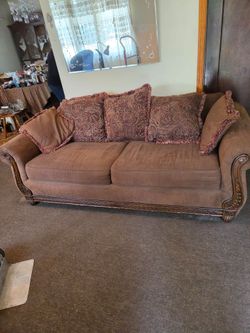 Brown Fabric sofa traditional wood trim decorative paisley reversible cushions