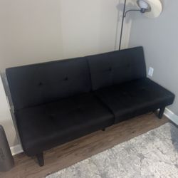 black couch, lamp, coffee table, dining table