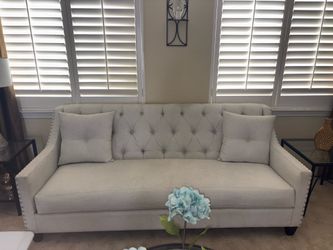 Fabric sofa and chair with nail studs