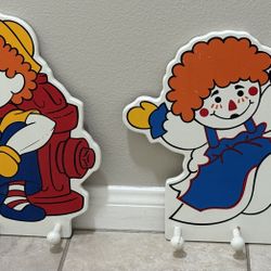 RAGGEDY ANN ANDY UCLA NURSERY WALL HANGINGS CLOTHES HOOKS LOT OF 2 MEASURES 17 H X 16 W  Asking $15 