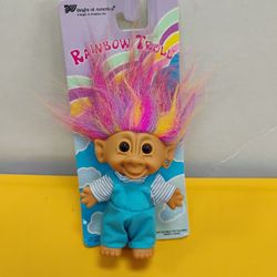 Vintage Bright of America "Rainbow Troll" doll still on its original card features bright, multi-colored hair and is dressed in blue overalls with a h