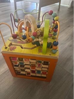 This is a B. toys Zany Zoo wooden activity cube with a bead maze on top.