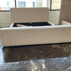 New king size platform bed light khaki color fabric upholstered.