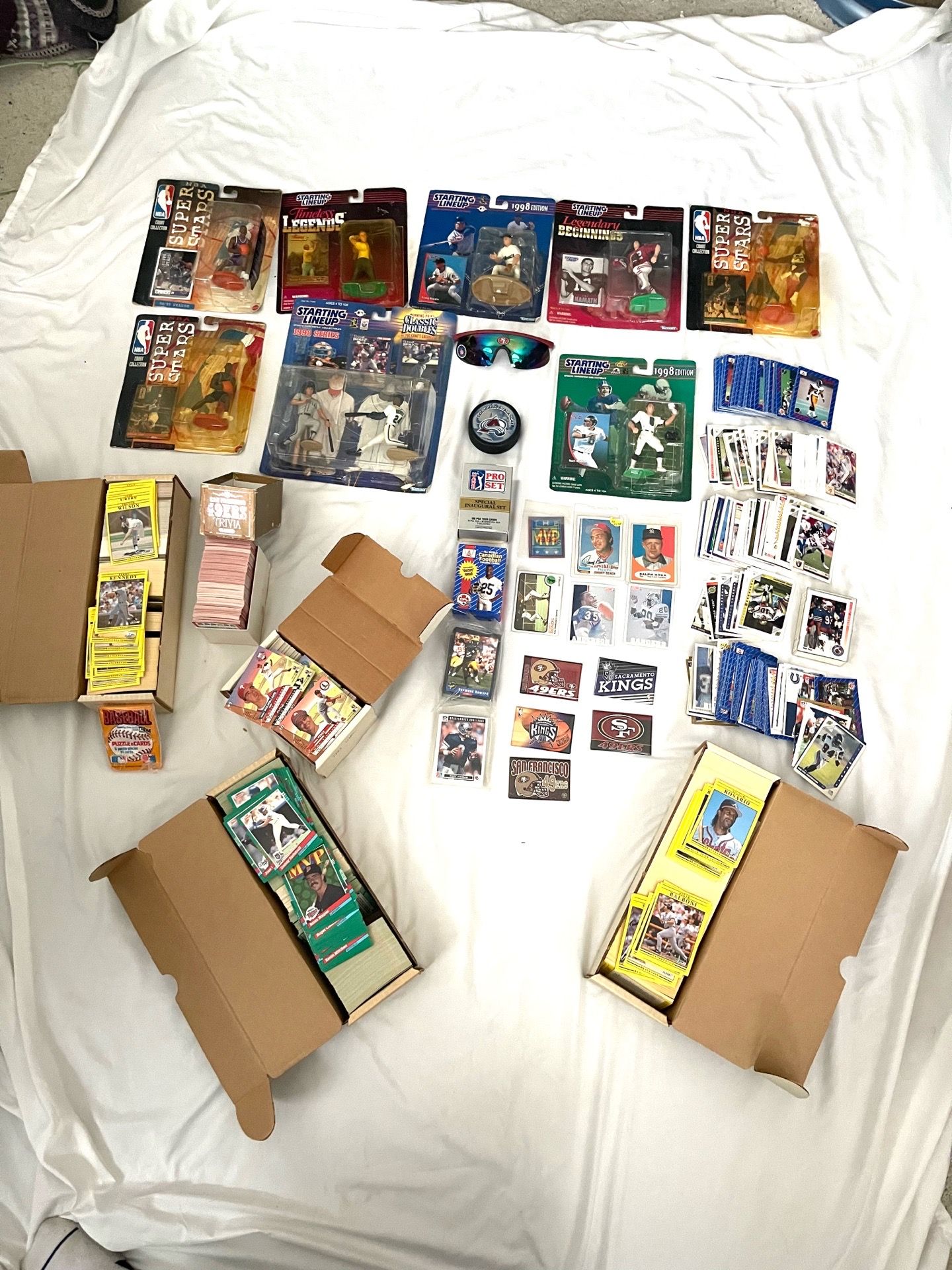 Big collection of sports action figures, lots of trading cards and other sports memorabilia