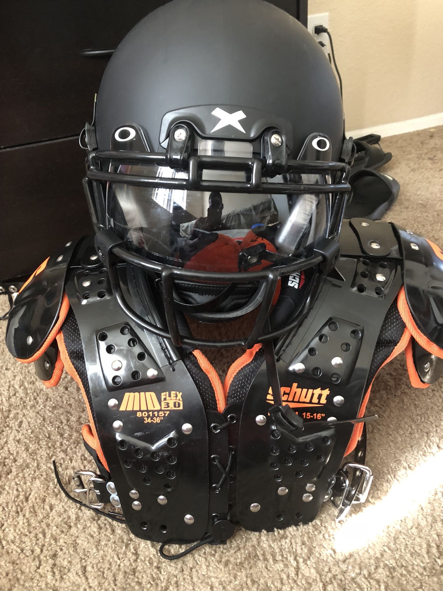 Xenith Youth large/adult medium helmet. Adult medium shoulder pads. Oakley Football visor included.