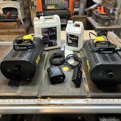2 Fog Machines, 2 Controllers, 2 Partial Jugs Of Fog Juice
