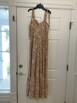 Brand New adorable women’s size small multicolored romper.