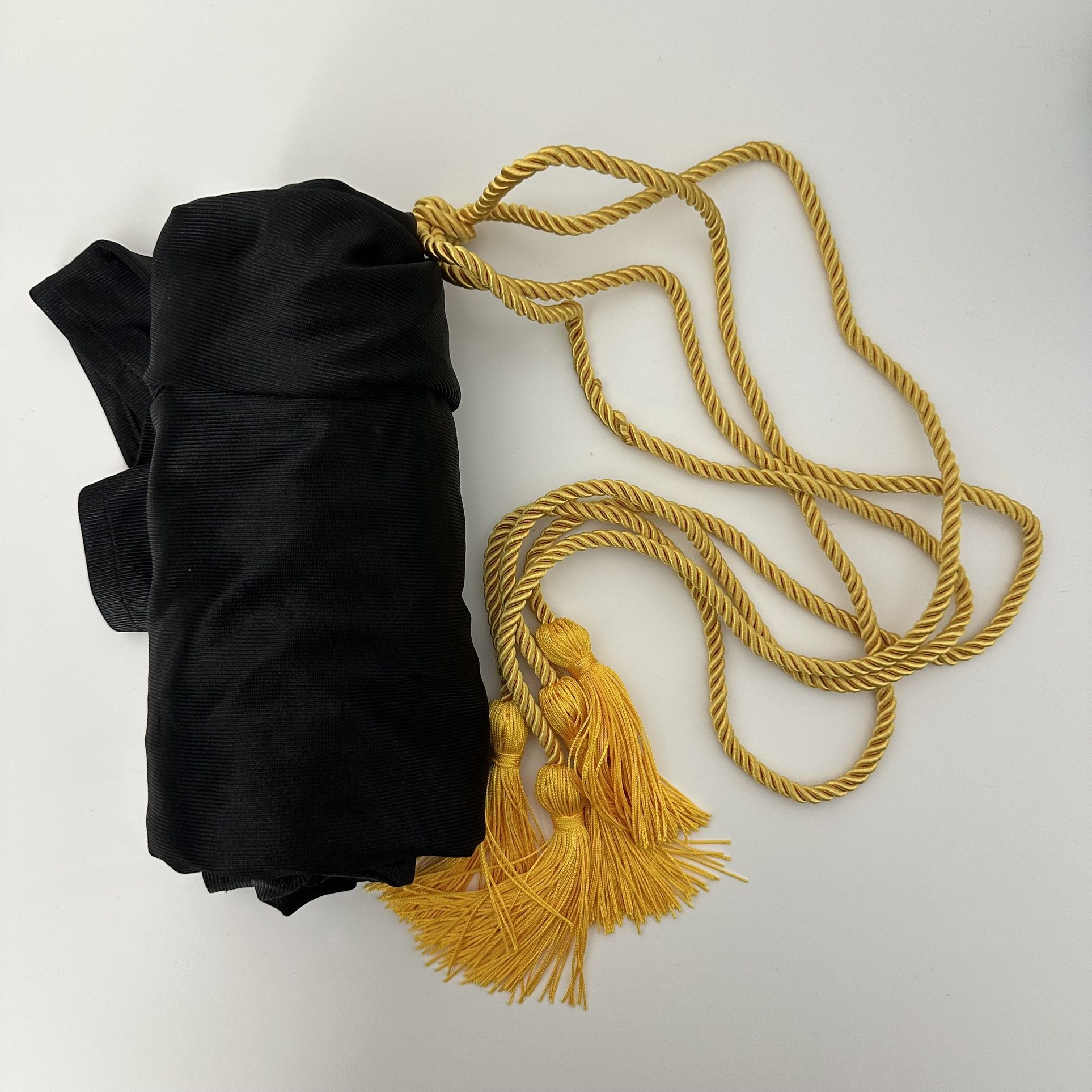 Black Cap Gown and Tassle (doesn’t say graduating year)